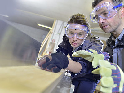 Instructor showing trainee how to use sawing machine Schlagwort(e): workshop, carpentry, woman, man, team, worker, working, education, teaching, trainee, apprenticeship, handicraft, craftsmanship, craftsman, construction, training, trainer, instructor, teacher, teaching, adults, caucasian, european, indoors, people, overalls, machines, workbench, carpenter, woodworking, job, occupation, professional, safety, security glasses, protection, equipment, wood plank, sawing machine, saw, gloves, workshop, carpentry, woman, man, team, worker, working, education, teaching, trainee, apprenticeship, handicraft, craftsmanship, craftsman, construction, training, trainer, instructor, teacher, adults, caucasian, european, indoors, people, overalls, machines, workbench, carpenter, woodworking, job, occupation, professional, safety, security glasses, protection, equipment, wood plank, sawing machine, saw, gloves