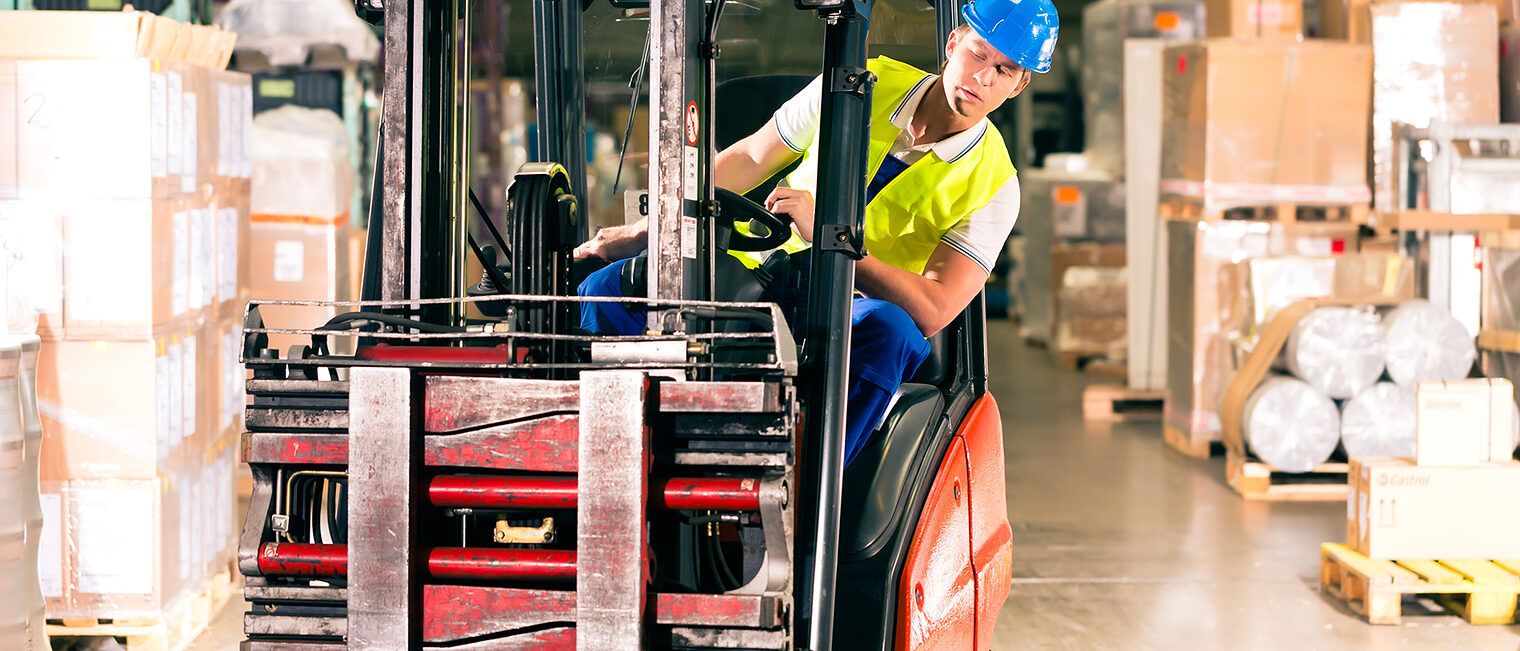 forklift driver in protective vest driving forklift at warehouse of freight forwarding company Schlagwort(e): Forwarding, freight forwarding, Forklift, shipping, shipper, company, business, Man, express, worker, cargo, transport, male, warehouse, logistics, depot, people, Person, driver, package, parcel, Caucasian, cardboard, box, container, forklift driver, driving, hardhat, confident, confidence, safety, helmet, protective, Warehouseman, work wear, vest, delivery, store man, machinery, vehicle, order, pallet, fast, speedy, serious, storage, stock, smiling, industry, job