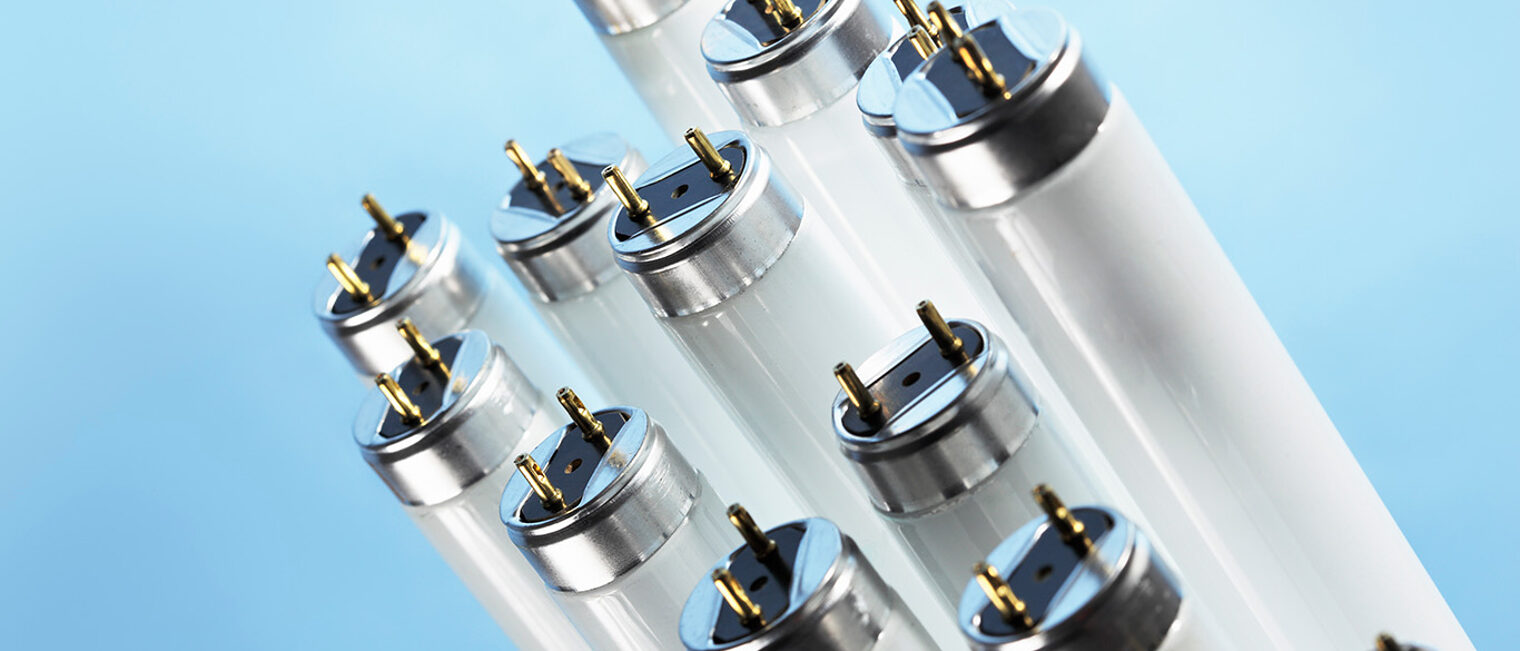 New fluorescent light tubes on blue background Schlagwort(e): fluorescent, light, lighting, tube, tubes, lamp, lamps, T8, T-8, pin, pins, component, electric, electrical, electrics, nobody, objects, object
