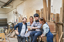 Junges Handwerker Start-Up Team mit Laptop Computer in der Schreinerei Werkstatt Schlagwort(e): Team, Handwerker, Tablet, Computer, online, Social Media, Werkstatt, Nachricht, Kommunikation, Mann, digital, mobil, PC, Gruppe, Kollegen, Frau, Schreinerei, Tischlerei, Schreiner, Tischler, Holz, Laptop, Holzarbeit, Handwerk, Zimmerei, Arbeit, Beruf, Bau, Arbeiter, Holzarbeiter, Holzverarbeitung, weiblich, jung, arbeiten, Leute, mittelständisch, Mittelstand, Betrieb, Handwerksbetrieb, Start-Up, team, handwerker, tablet, computer, online, social media, werkstatt, nachricht, kommunikation, mann, digital, mobil, pc, gruppe, kollegen, frau, schreinerei, tischlerei, schreiner, tischler, holz, laptop, holzarbeit, handwerk, zimmerei, arbeit, beruf, bau, arbeiter, holzarbeiter, holzverarbeitung, weiblich, jung, arbeiten, leute, mittelständisch, mittelstand, betrieb, handwerksbetrieb, start-up